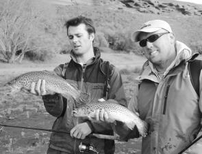 Scott Gray (right) and Neil Tedesco with two nice brown trout caught from shore for the cameras while filming an episode of Adventure Bound at Lake Purrumbete. The fish took 3 and 4 inch Gulp Minnows in Smelt colour rigged on 1g jigheads and cast t